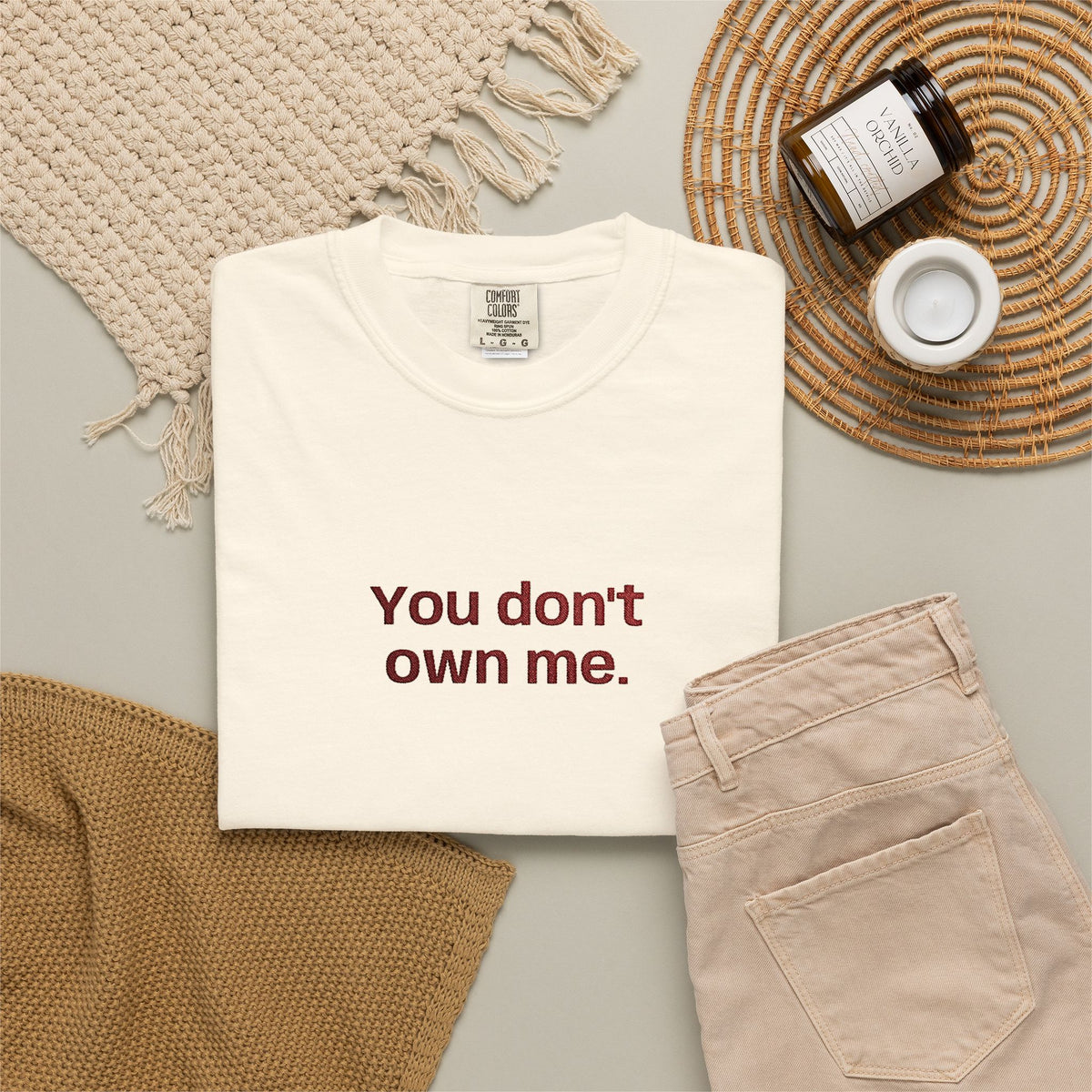 White folded T-shirt with 'You don't own me.' front graphic