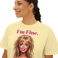 Boxy butter yellow graphic tee with “I'm Fine.” text and doll face print, crew neck.
