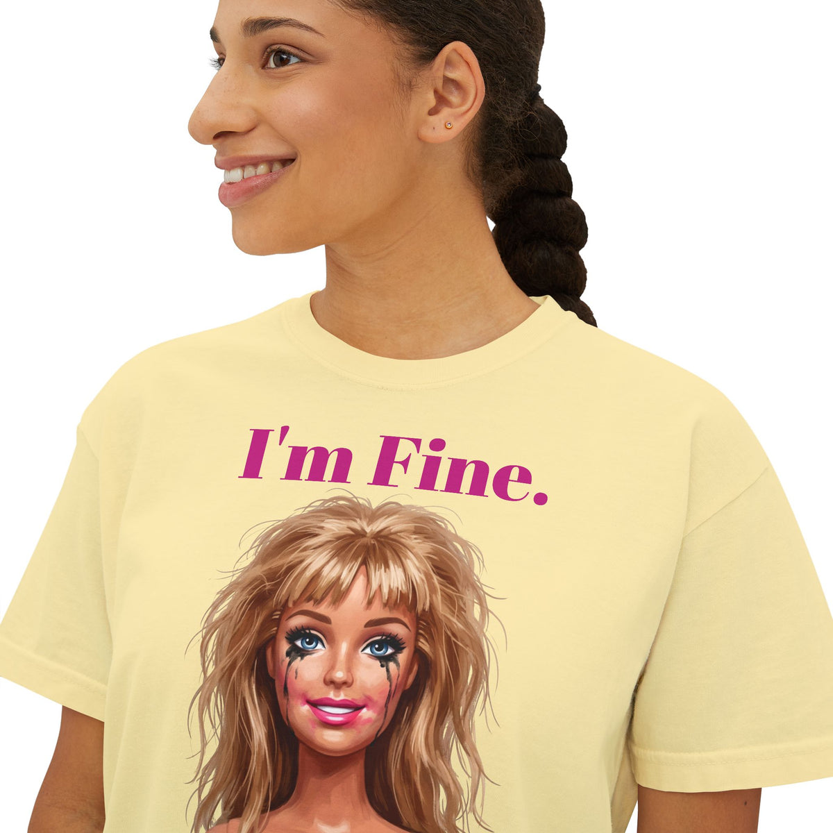 Boxy butter yellow graphic tee with “I'm Fine.” text and doll face print, crew neck.