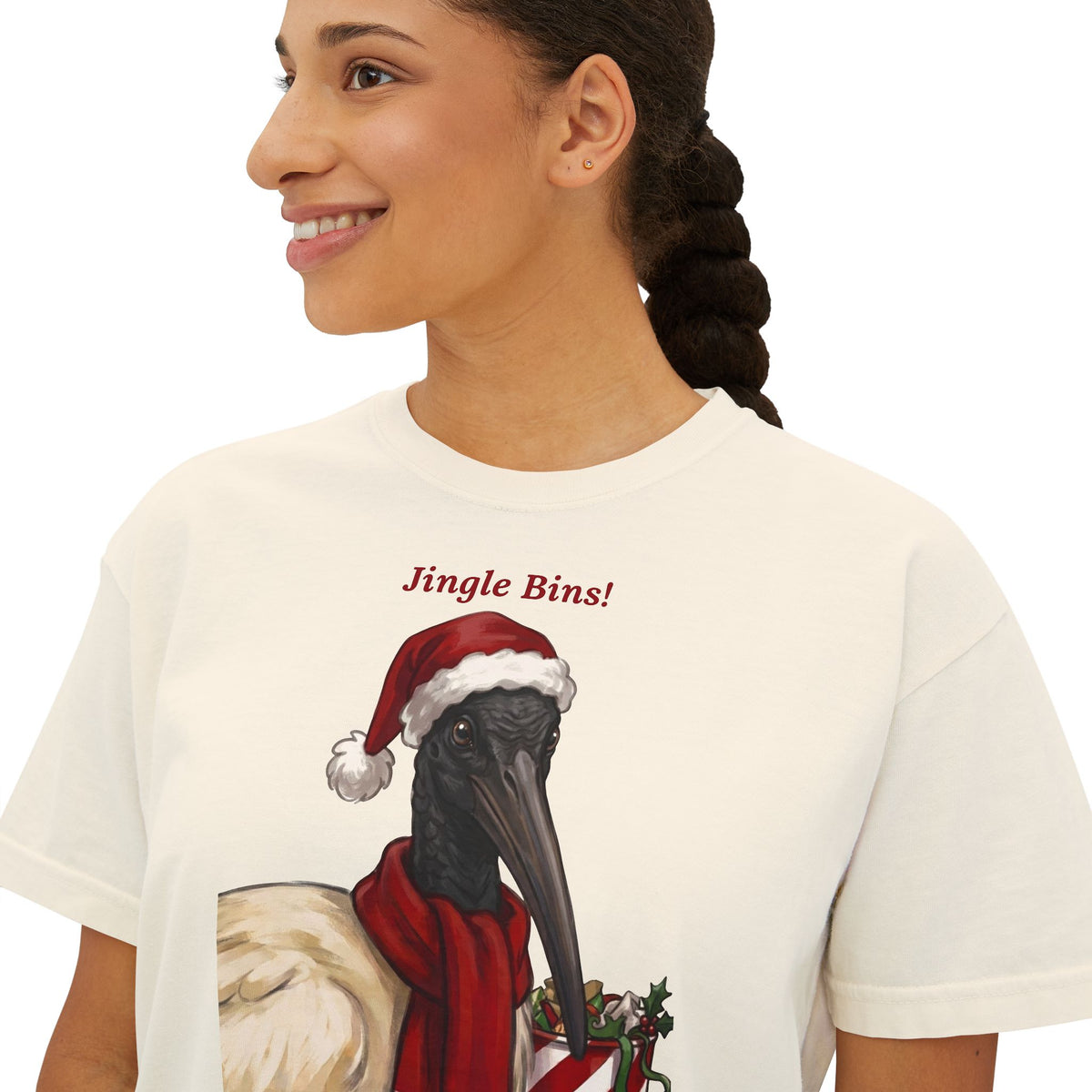 Ivory T-shirt close-up of 'Jingle Bins!' ibis in Santa hat graphic