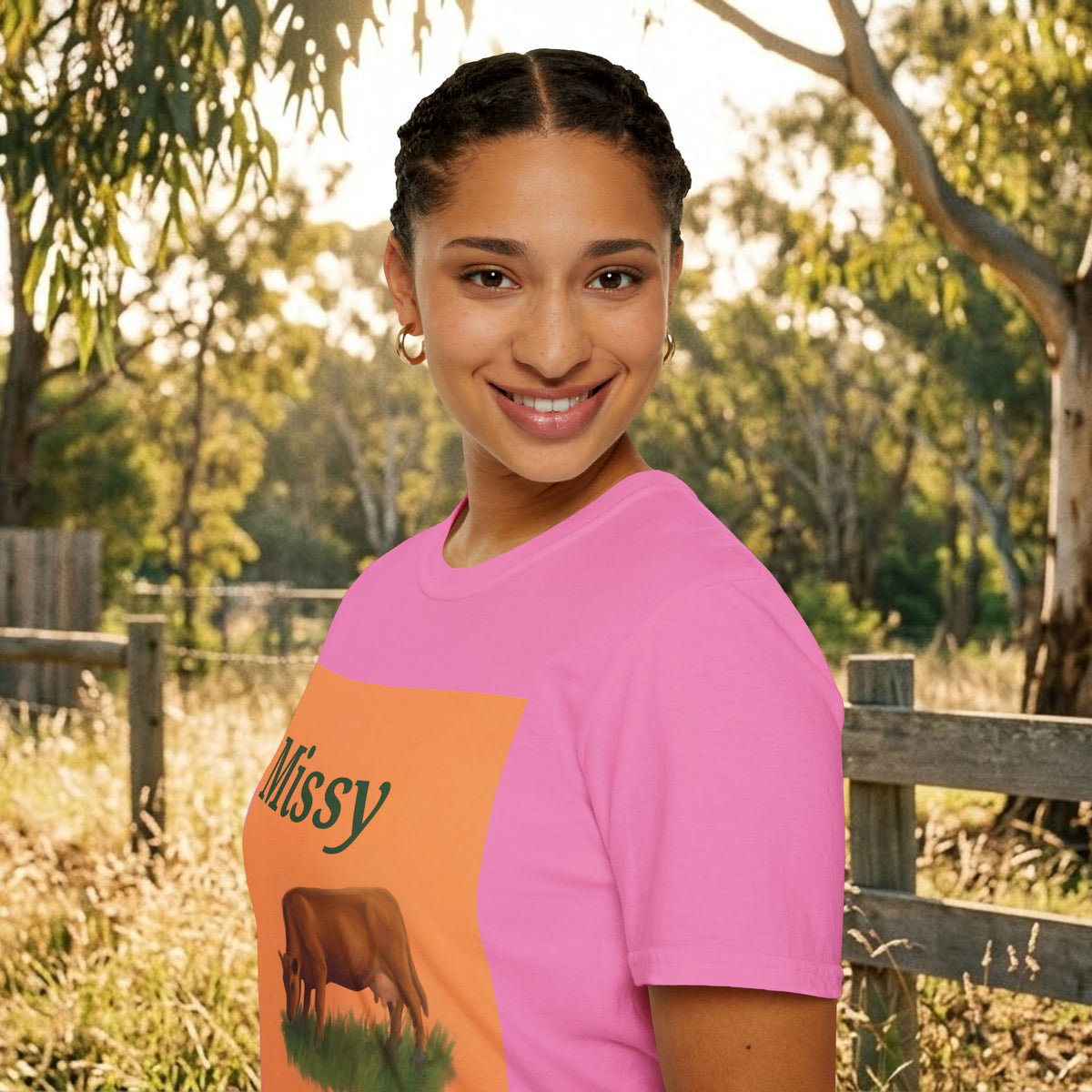 Pink cow graphic t-shirt with orange panel and grazing cow illustration, side view