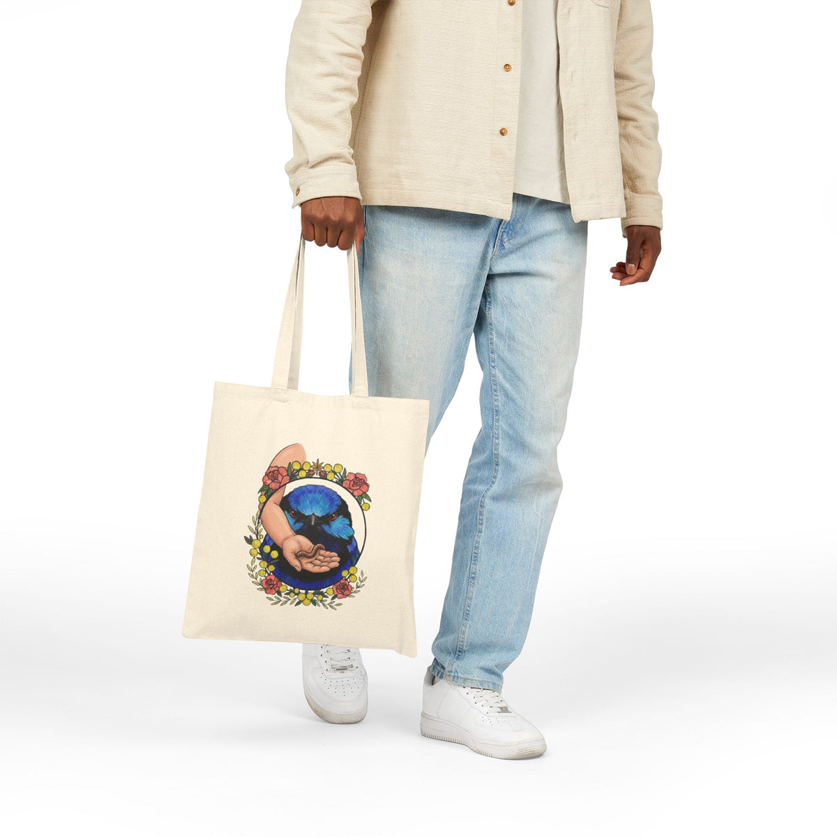Natural canvas tote bag with blue-toned hand-and-grubs graphic, long handles