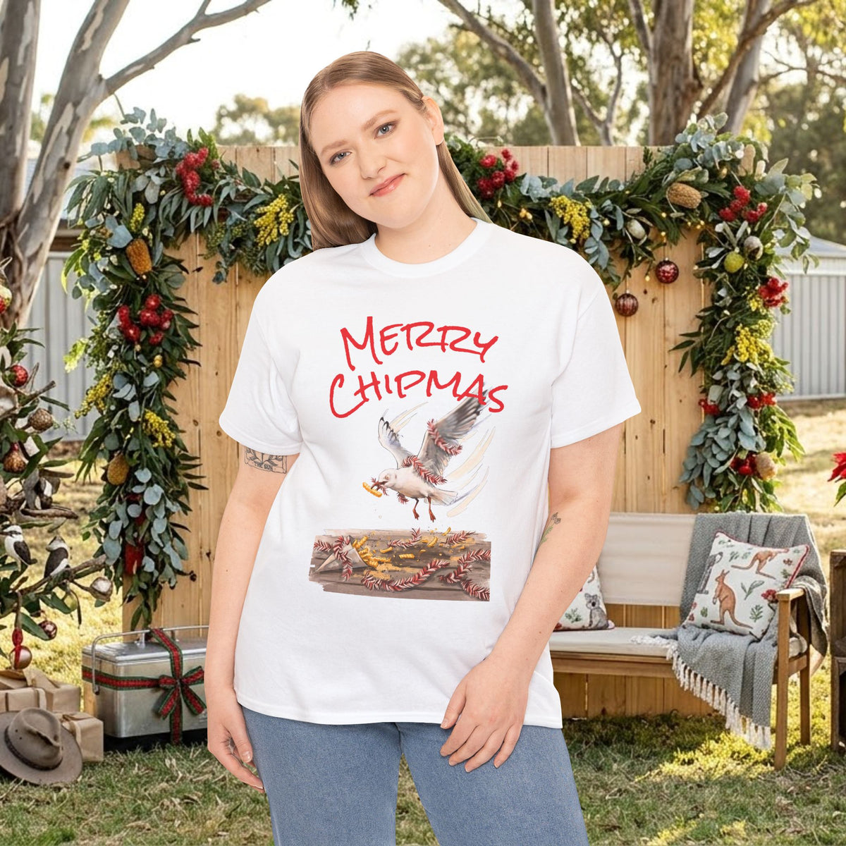 White holiday tee with red “Merry Chipmas” seagull illustration graphic on chest