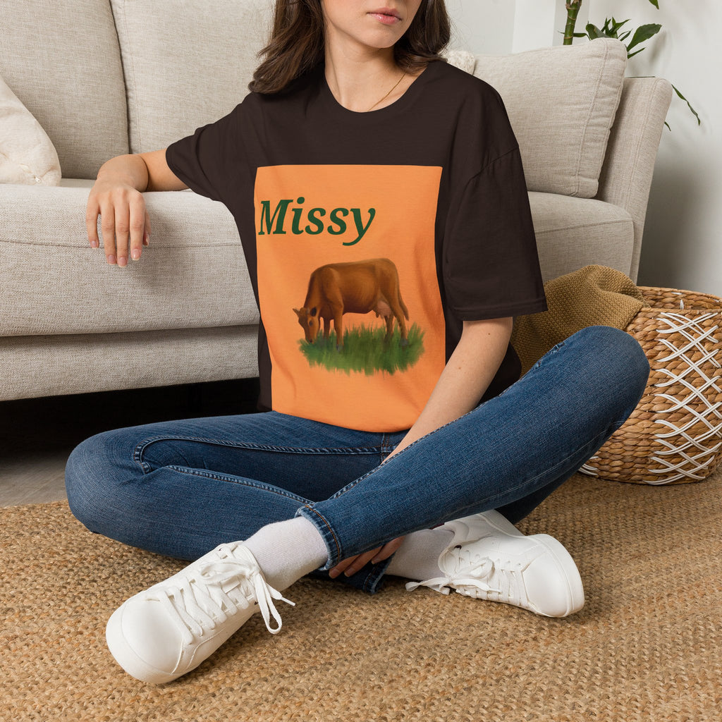Dark brown cow graphic T-shirt with orange square print, worn with blue jeans