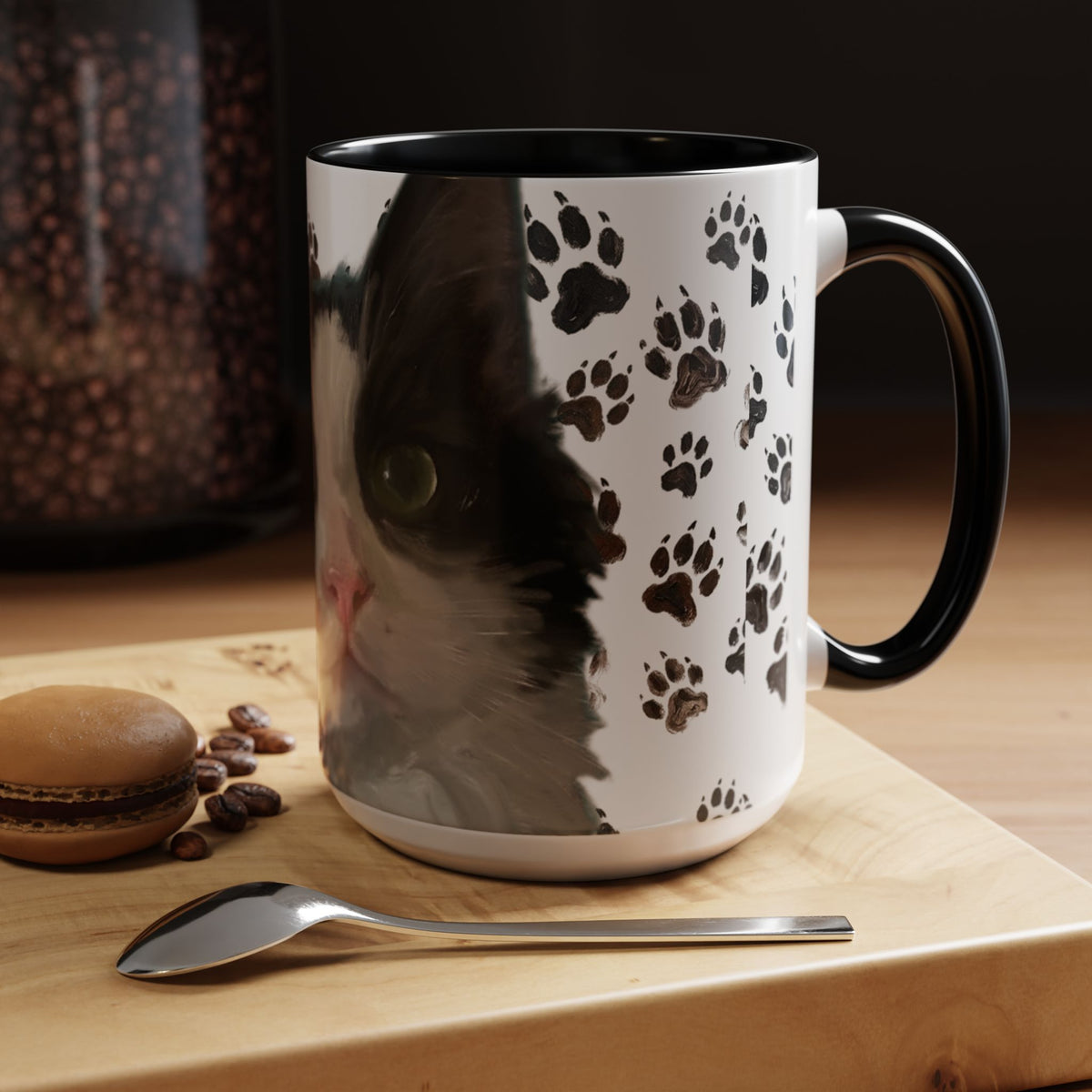 Black cat face accent coffee mug with paw print pattern, white body, black handle