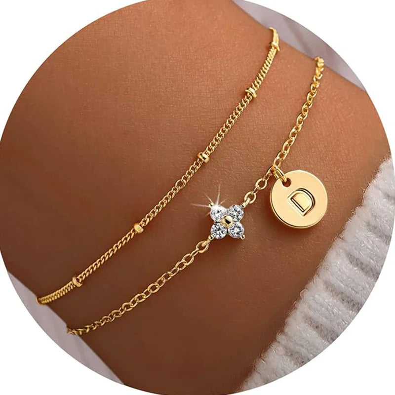 Gold clover initial bracelet with cubic zirconia by Kat&Co.