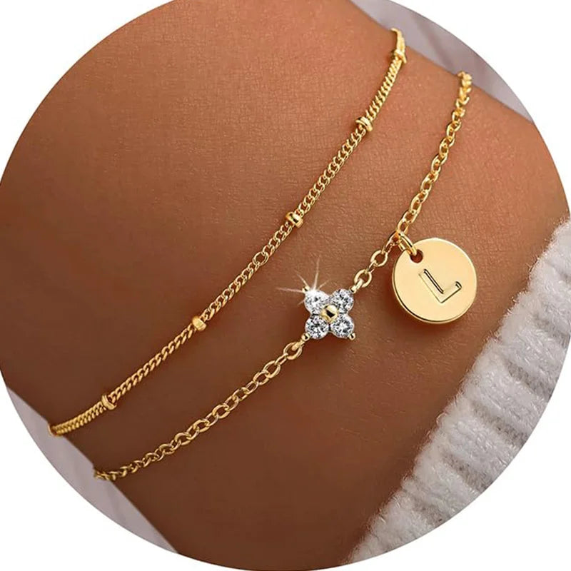 Gold clover initial bracelet with cubic zirconia by Kat&Co.