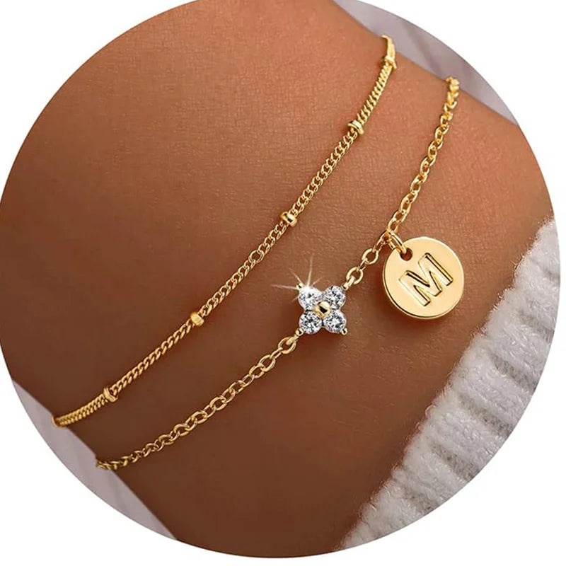 Gold clover initial bracelet with cubic zirconia by Kat&Co.