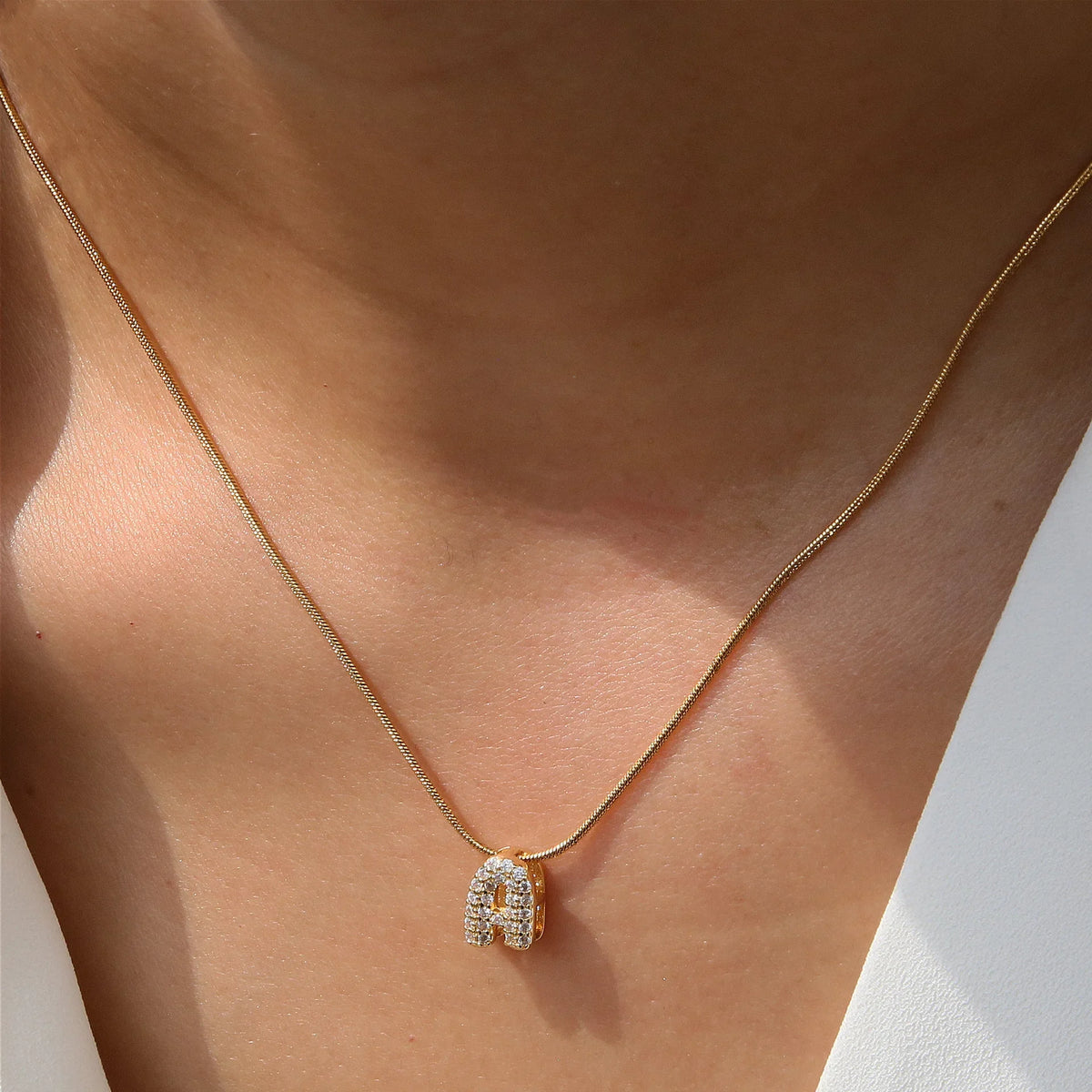 Dainty zircon initial letter necklace by Kat&Co.