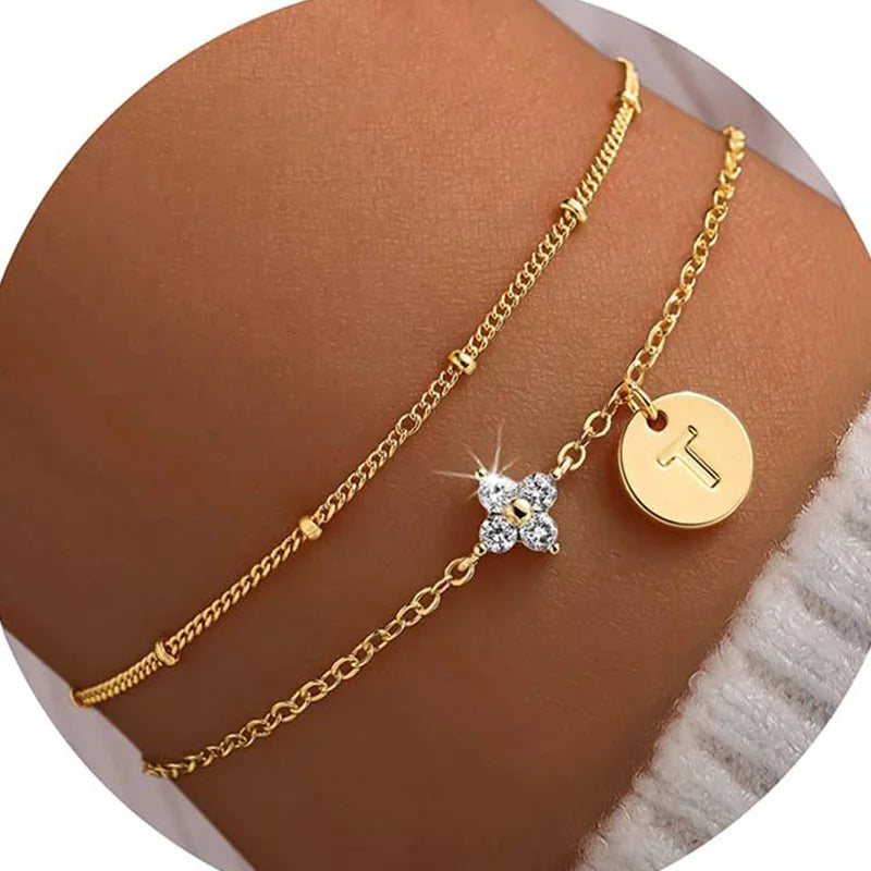Gold clover initial bracelet with cubic zirconia by Kat&Co.