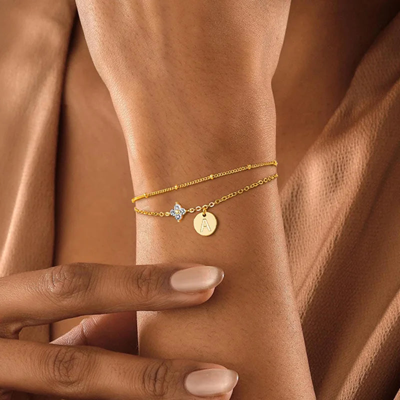 Gold clover initial bracelet with cubic zirconia by Kat&Co.