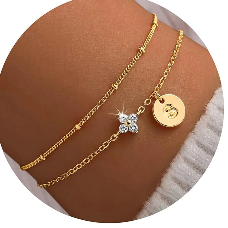 Gold clover initial bracelet with cubic zirconia by Kat&Co.