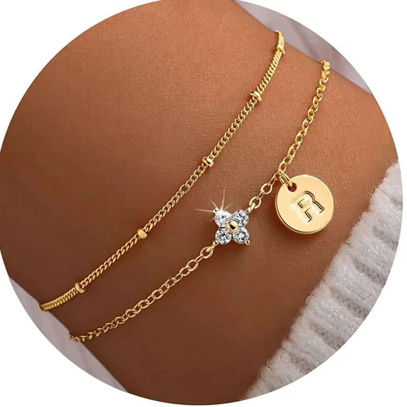Gold clover initial bracelet with cubic zirconia by Kat&Co.