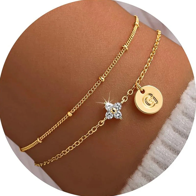 Gold clover initial bracelet with cubic zirconia by Kat&Co.