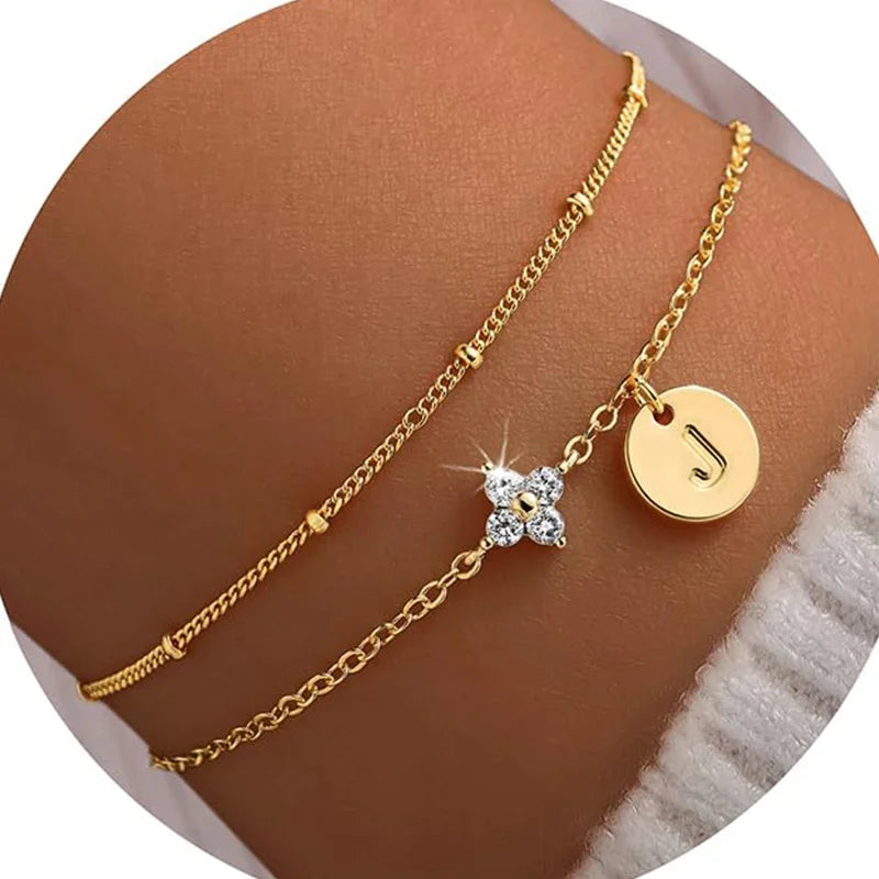 Gold clover initial bracelet with cubic zirconia by Kat&Co.
