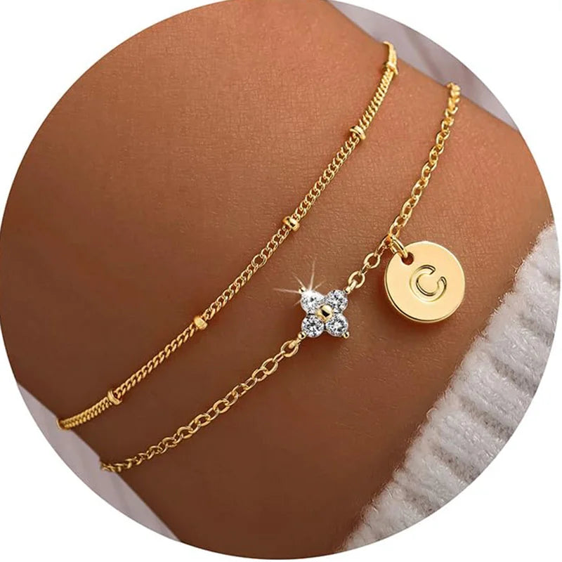 Gold clover initial bracelet with cubic zirconia by Kat&Co.