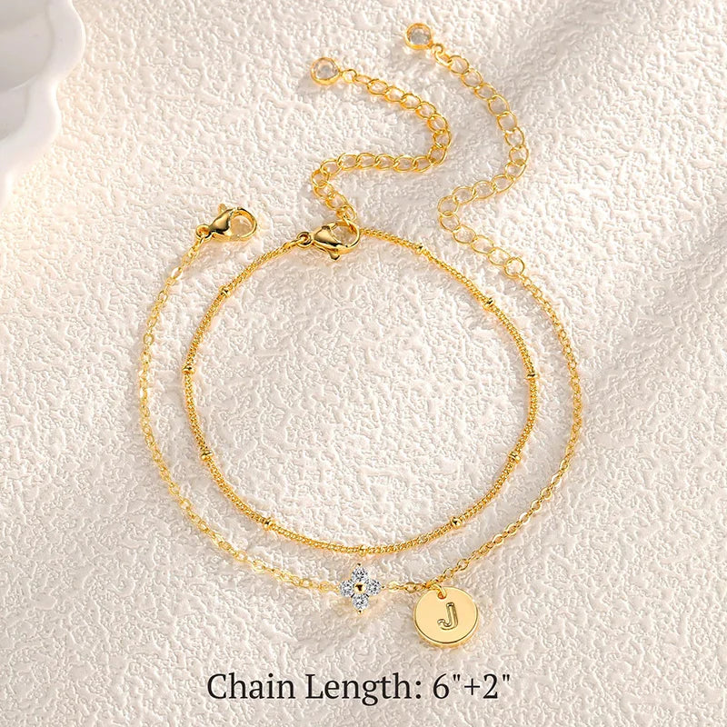Gold clover initial bracelet with cubic zirconia by Kat&Co.