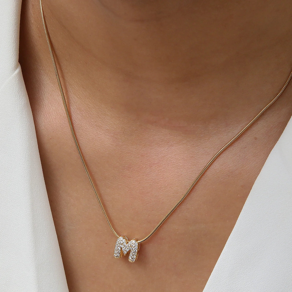 Dainty zircon initial letter necklace by Kat&Co.