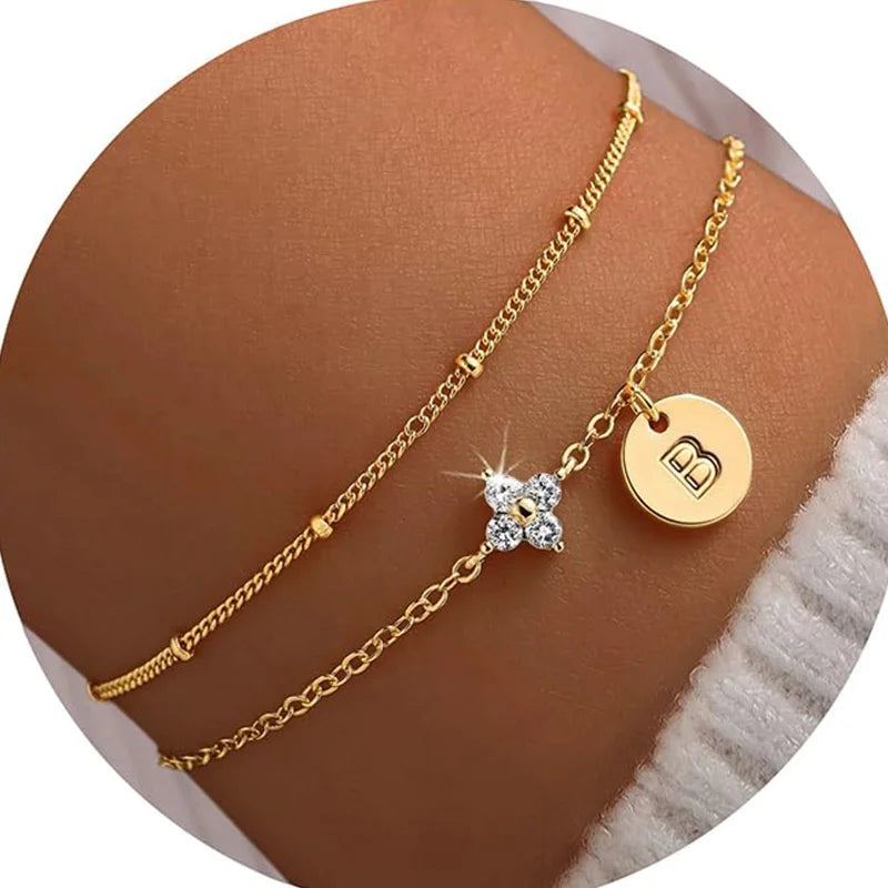 Gold clover initial bracelet with cubic zirconia by Kat&Co.