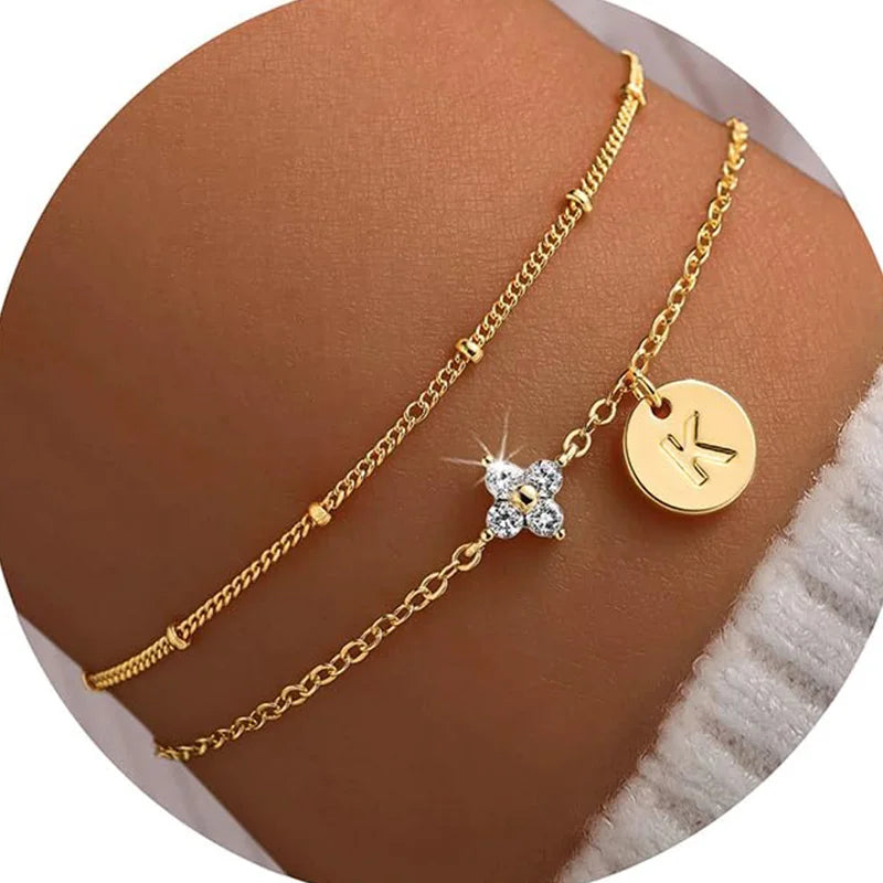 Gold clover initial bracelet with cubic zirconia by Kat&Co.