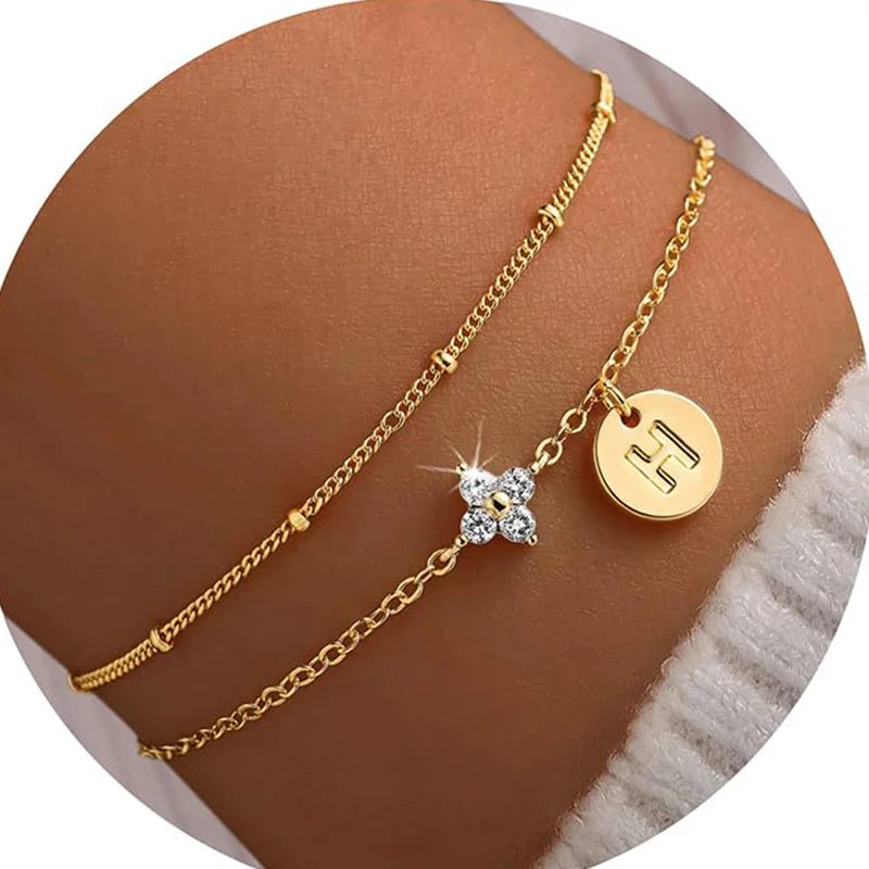 Gold clover initial bracelet with cubic zirconia by Kat&Co.